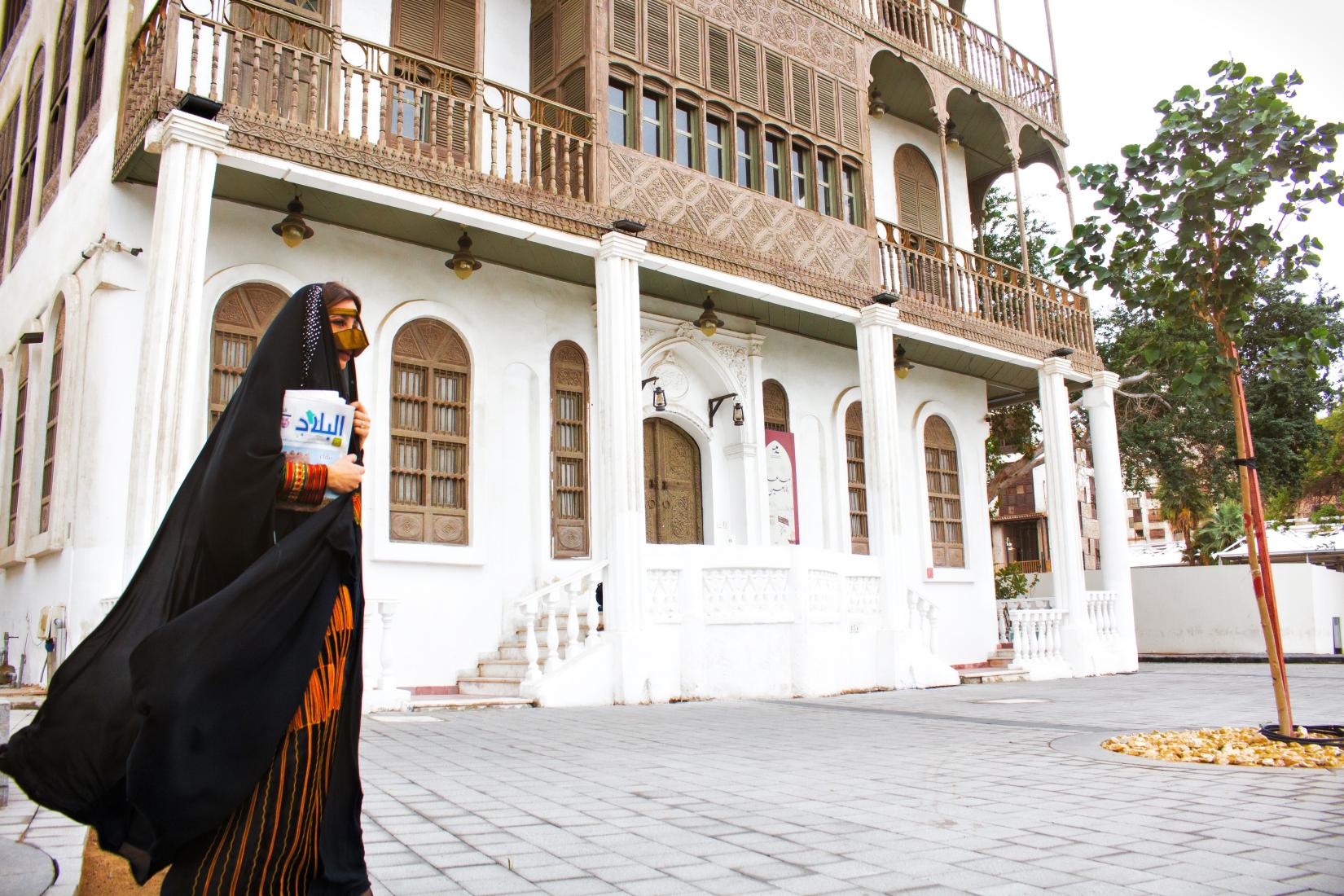 Photo of Woman holding newspaper in Jeddah Old Town